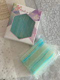 Crystal candy prisms beside a Petals in Prism gift box